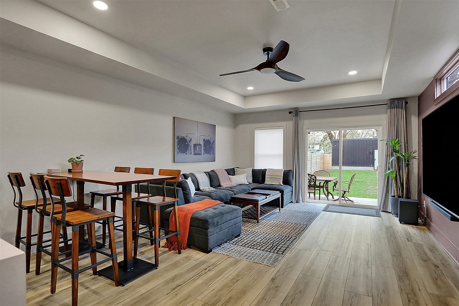 Primary suite with king bed, peach and sage color-block walls, wall TV, and en-suite access