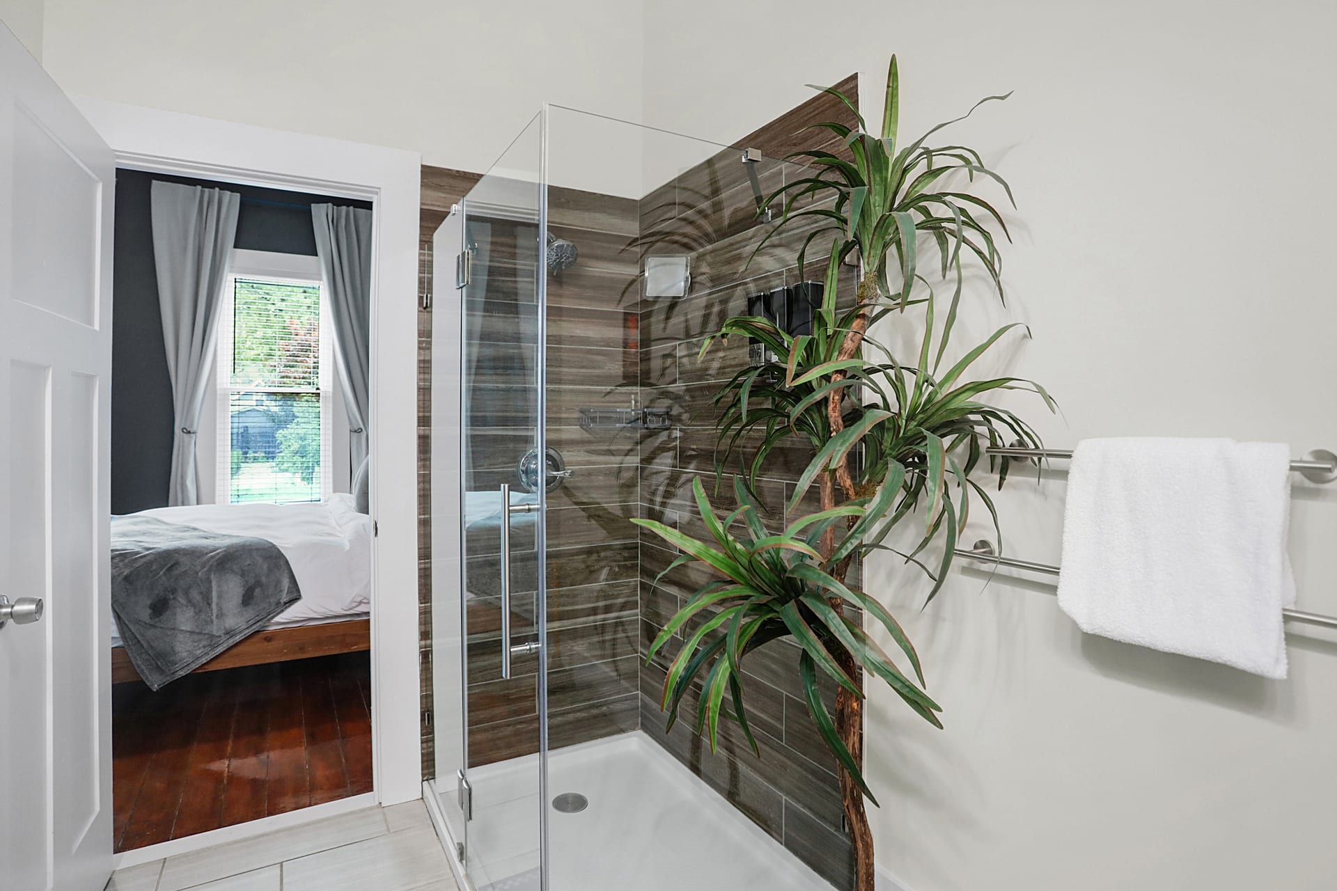 Yellow powder room with console sink, framed mirror, and hotel-style rolled towels