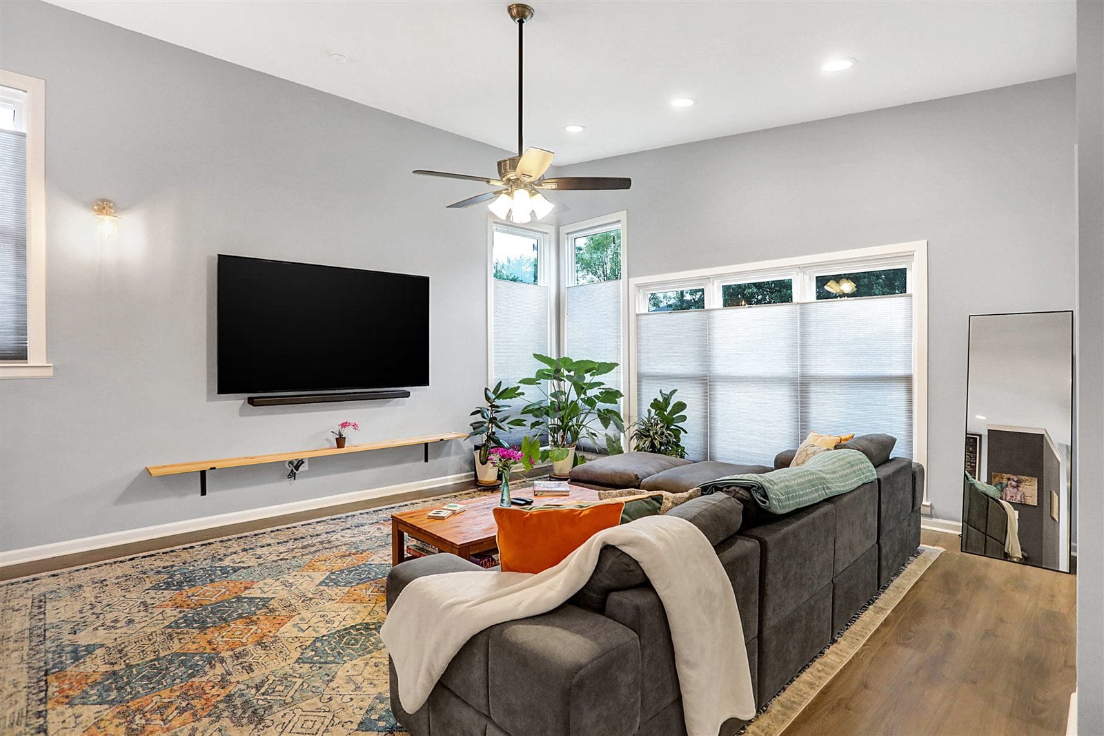 White shaker kitchen with swirled granite counters, subway tile, and vaulted ceiling